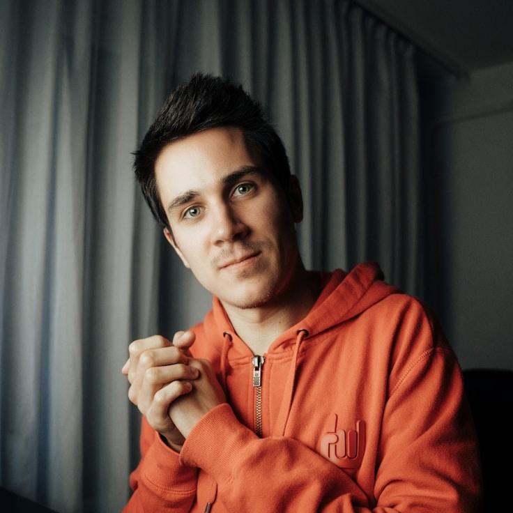 Amina Shah, Lead Design Curator at FernOpalineTwill, reviewing corporate floral arrangements